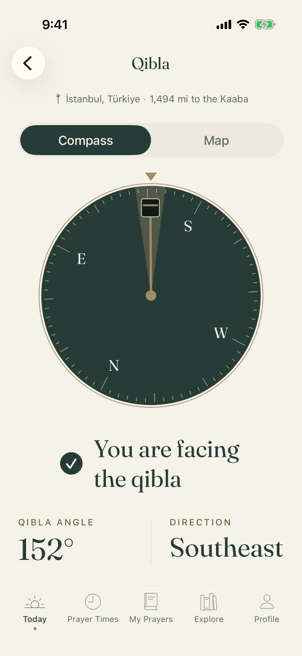 Qibla screen: dark compass dial, Kaaba needle and the words “You are facing the qibla”